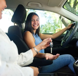 Zoom HD woman giving keys to daughter